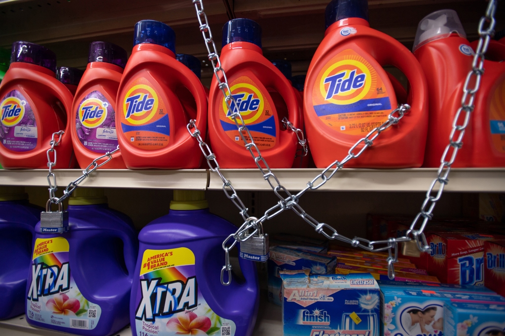 Chained up bottles of Tide and Xtra detergent